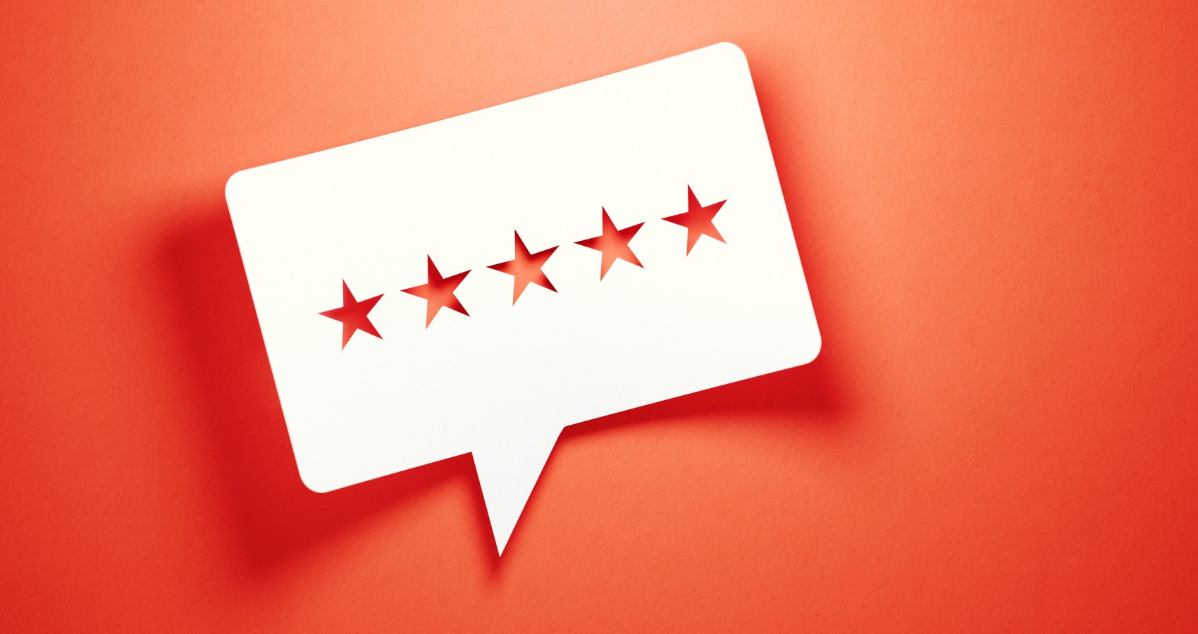 Feedback concept white chat bubble cut out stars red background
